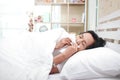 Elderly women In bed in the bedroom She is ill with influenza, high fever, body aches, dry cough, sore throat and runny nose.