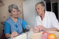 Elderly woman comforts her friend