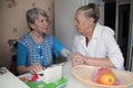 Elderly woman comforts her friend