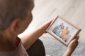 Elderly woman with framed family portrait Royalty Free Stock Photo