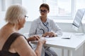 elderly woman with glasses diagnostics health complaint