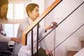 Elderly woman hands holding sticks while walking up stair at home,Caregiving take care and support,Self-Care for Family Caregivers