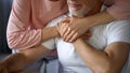 Elderly woman hugging husband, family connection, love expression, grandparents