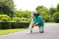 Elderly women jogging in the park She has pain in her right knee.