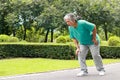 Elderly women jogging in the park She has pain in her right knee.