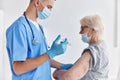 elderly woman next to the doctor arm injection vaccine passport hospital Royalty Free Stock Photo