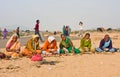 Elderly women prepare prasadam to a religious ceremony in a desert