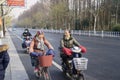 Elderly women rides bicycle in Hangzhou