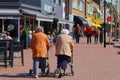 Elderly women together walking rollator street, Netherlands