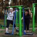 Elderly woman on a sports simulator in the Park.