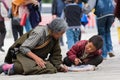 Elderly women and teenagers begging on the streets of Lhasa, Tibet