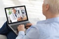 Elderly woman using laptop at home, making video call with doctor, having online conference with medical specialist Royalty Free Stock Photo