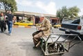 Elderly worker counts the money earned for a rough day