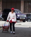 Elderly Yakult Lady Walking Down The Street Royalty Free Stock Photo