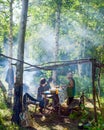 Elderly Yakuts set the table in a place to rest in the wild Northern forest in the smoke from the fire