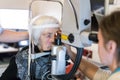 Senior woman during laser surgery at ophthalmology clinic.