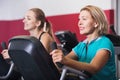 Elderly and young women working out in gym Royalty Free Stock Photo