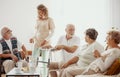 Elders spending time in the common room of the care home Royalty Free Stock Photo