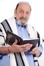 Eldery jewish man wrapped in talit praying