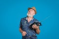 Eldery man holding retro portable radio with antenna. Gentleman with straw hat and gray beard looking up and away portrait Royalty Free Stock Photo