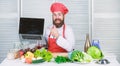 Elearning concept. Chef laptop read culinary recipes. Culinary school. Hipster in hat and apron learning how to cook Royalty Free Stock Photo