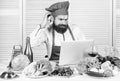 Elearning concept. Man chef searching internet recipe cooking food. Chef laptop read culinary recipes. Culinary school Royalty Free Stock Photo