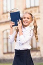 Elearning and modern methods. Girl cute schoolgirl hold book and headphones. Knowledge assimilate better this way. Audio Royalty Free Stock Photo