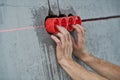 Elecrician work. Installing wall electric outlet with laser level