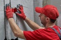 Elecrician work. Installing wall electric outlet with laser level