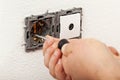 Electician hands installing electical wall sockets Royalty Free Stock Photo