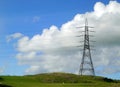 Electicity pylon on hillside.