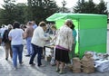 Election campaign. People taking leaflets from campaigners standing under a tent on a street