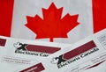 Election Canada voter information cards over small Canadian flag