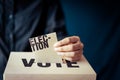 Election card insert in vote box, democracy concept Royalty Free Stock Photo