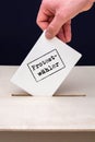 Election card is inserted in ballot box with the German word for protest voters on the card