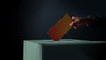 Election Concept. Person Dropping a Ballot Card into the Vote Box Royalty Free Stock Photo