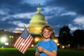 Election day for US Citizens. Kid with US flag near capitol building in Washington DC. Voting concept. American Flag Day Royalty Free Stock Photo