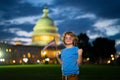 Election day for US Citizens. Kid with US flag near capitol building in Washington DC. Voting concept. American Flag Day Royalty Free Stock Photo