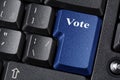 Election or democracy concept with blue Vote button on black keyboard. Close up.