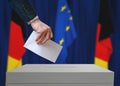 Election in Germany. Voter holds envelope in hand above vote ballot.