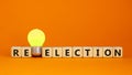 Election or reelection symbol. Cubes with words `Election reelection`. Yellow light bulb. Beautiful orange background. Business, Royalty Free Stock Photo