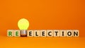 Election or reelection symbol. Cubes with words `Election reelection`. Yellow light bulb. Beautiful orange background. Business, Royalty Free Stock Photo