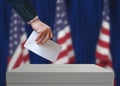 Election in United States of America. Voter holds envelope in hand above vote ballot. Royalty Free Stock Photo