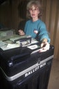 Election volunteer depositing ballots