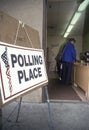 Election volunteers assisting voters in a polling place, CA