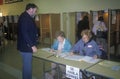 Election volunteers assisting voters in a polling place, CA