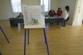 Election volunteers and voting booths in a polling place, CA