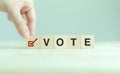 Election vote concept. Vote word with checkmark symbol on wooden cube blocks. Royalty Free Stock Photo