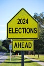 2024 Elections ahead in a traffic road sign on the side of street.