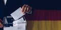 Elections in Germany. Man throwing his vote into the ballot box